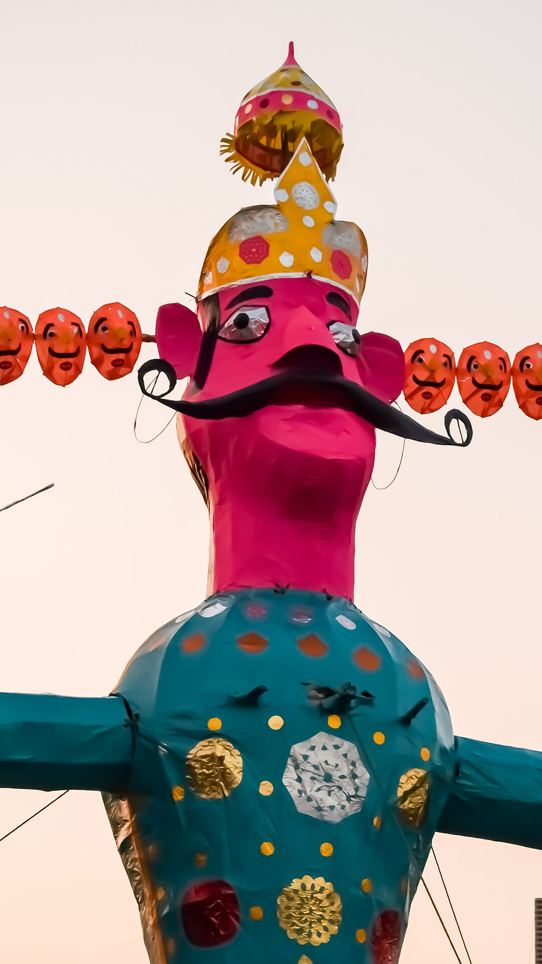 Close-up of the giant, colorful ten-headed effigy of Ravana for Dussehra celebrations.